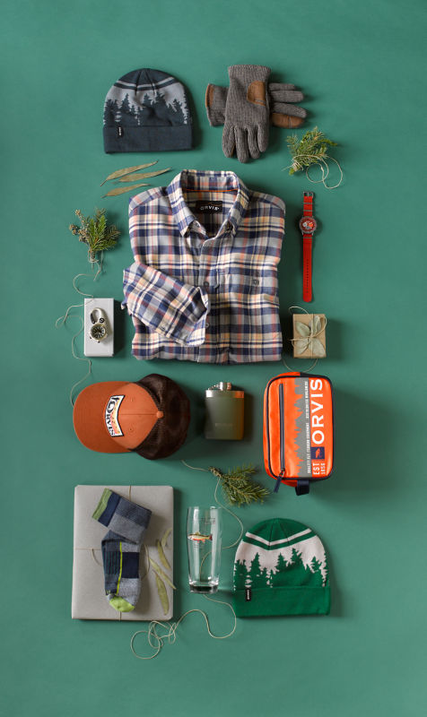 Assortment of personalized Orvis products on a teal background.